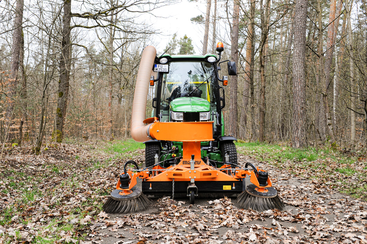 Saugkehrmaschine der Firma matev an einem Traktor für die Kommunaltechnik. Flächenpflege.